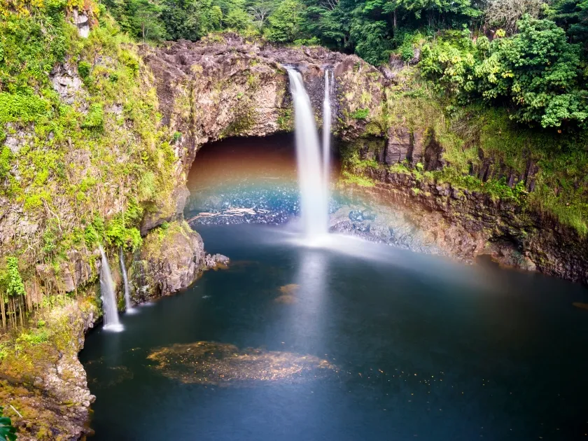 Rainbow Falls cascading over a lava cave on the Wailuku River in Hilo Hawaii — a stop on the Mauka Makai shore excursion
